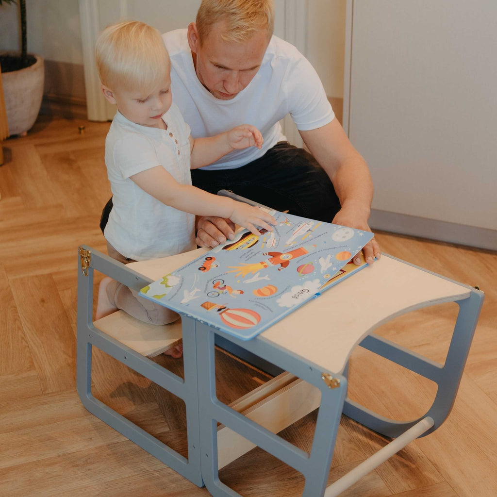 6. Child and adult reading book on grey kitchen tower in table mode