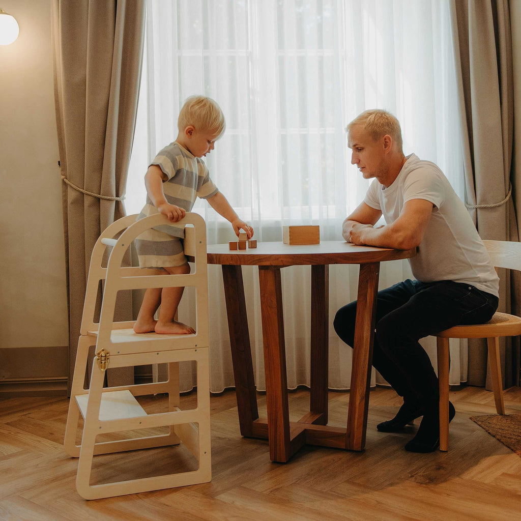 10. Child and adult using natural birch kitchen tower at dining table
