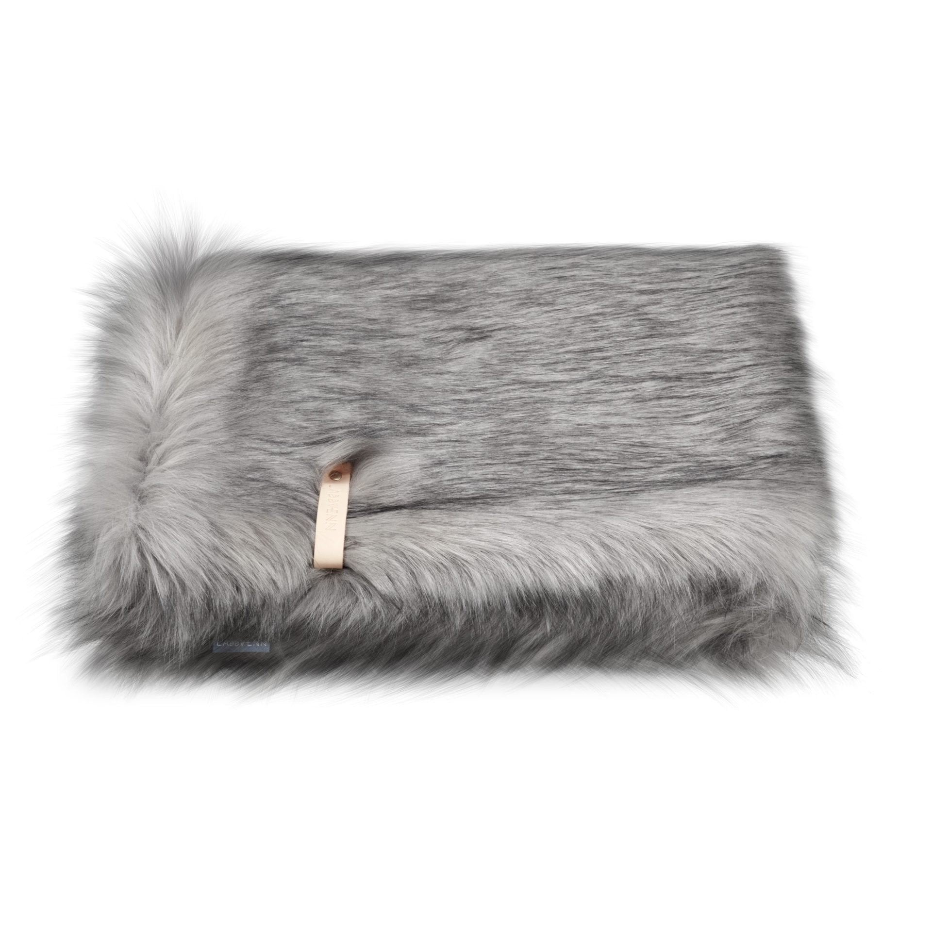 2. Silver faux fur blanket with leather strap detail on white background, showcasing fluffy texture