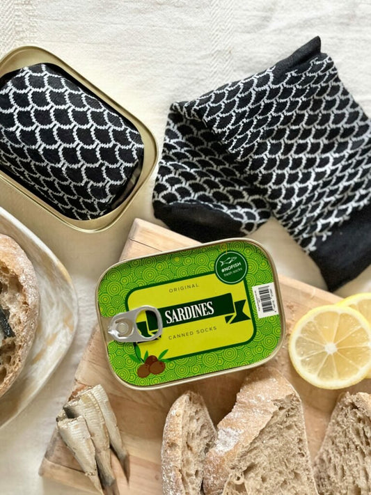 2. SEIK French Sardine Unisex Socks in a Can, black and white socks displayed with open can, lifestyle setting