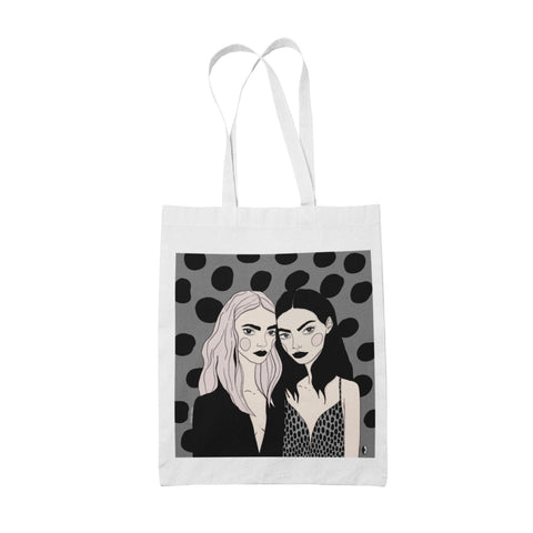 1. Women's tote bag featuring 'Love Your Sisters' illustration by Getter Tiivits, made of 100% cotton, shown in studio setting