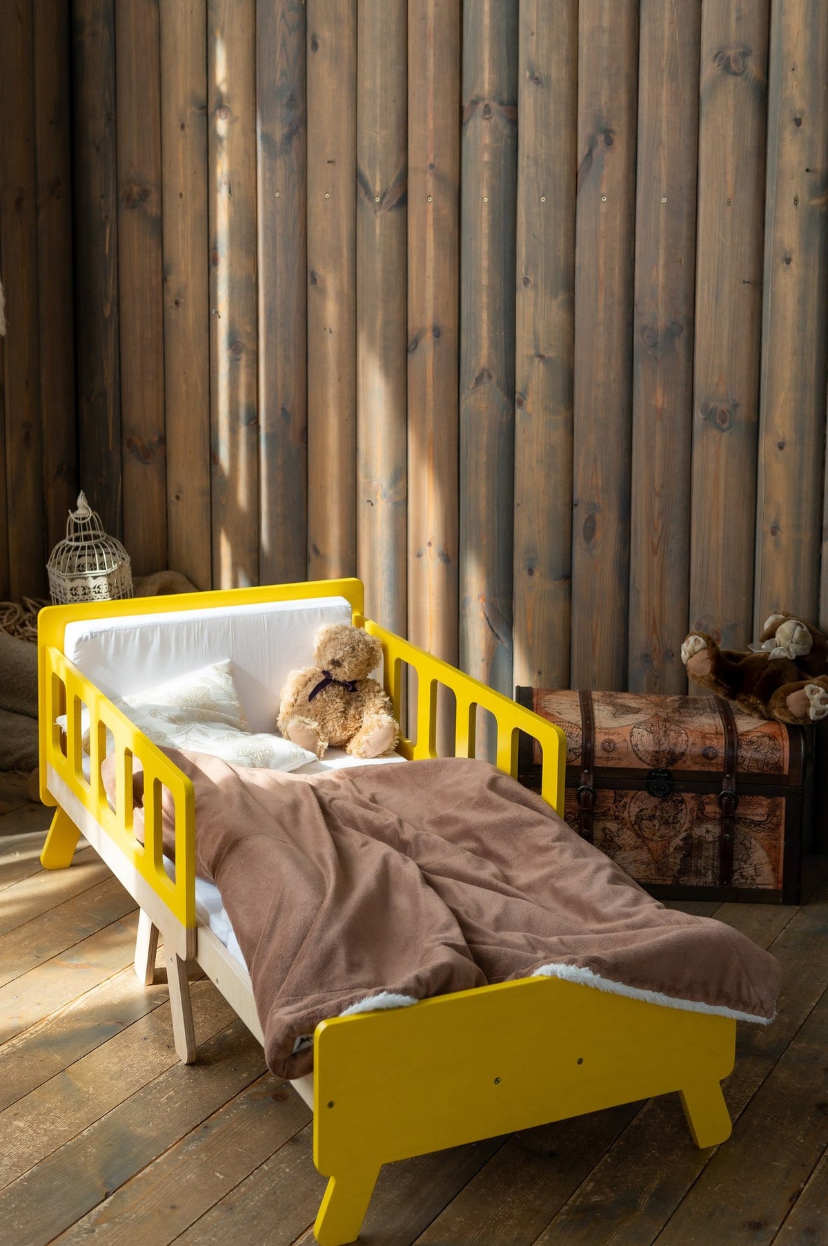 13. Yellow growing bed with brown blanket in rustic wooden room