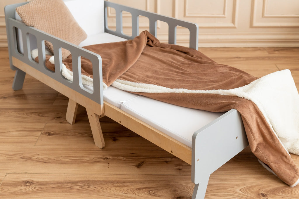 16. Close-up of grey and white growing bed with brown blanket in elegant room