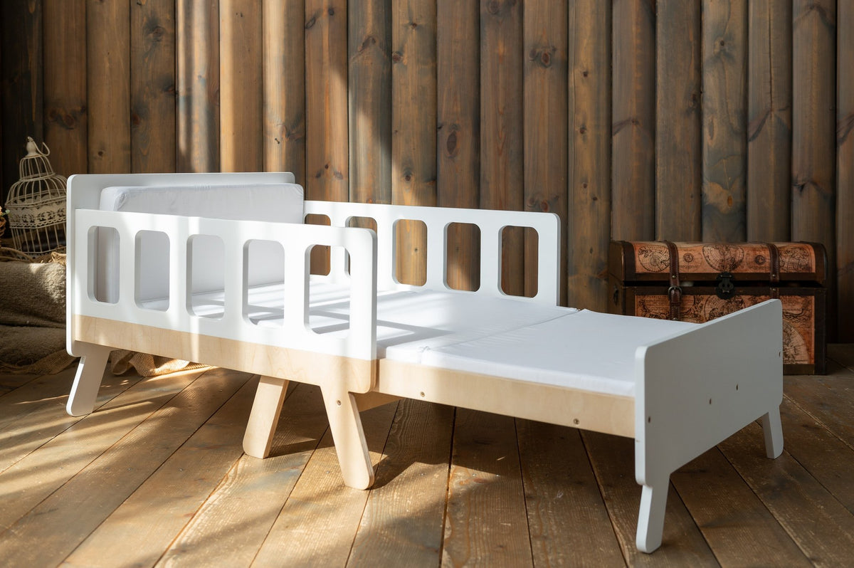 9. White growing bed with wooden legs and white bedding in rustic wooden room