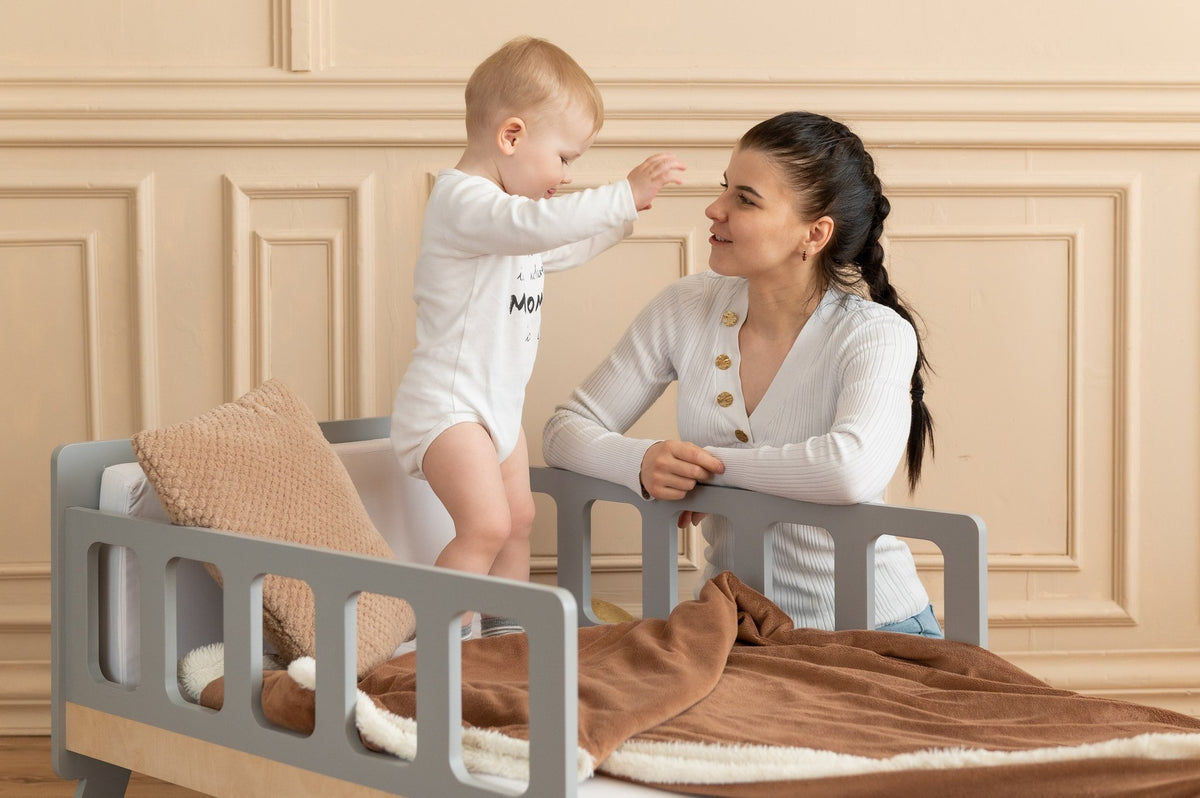 18. Woman and child interacting on grey growing bed with brown blanket in elegant room