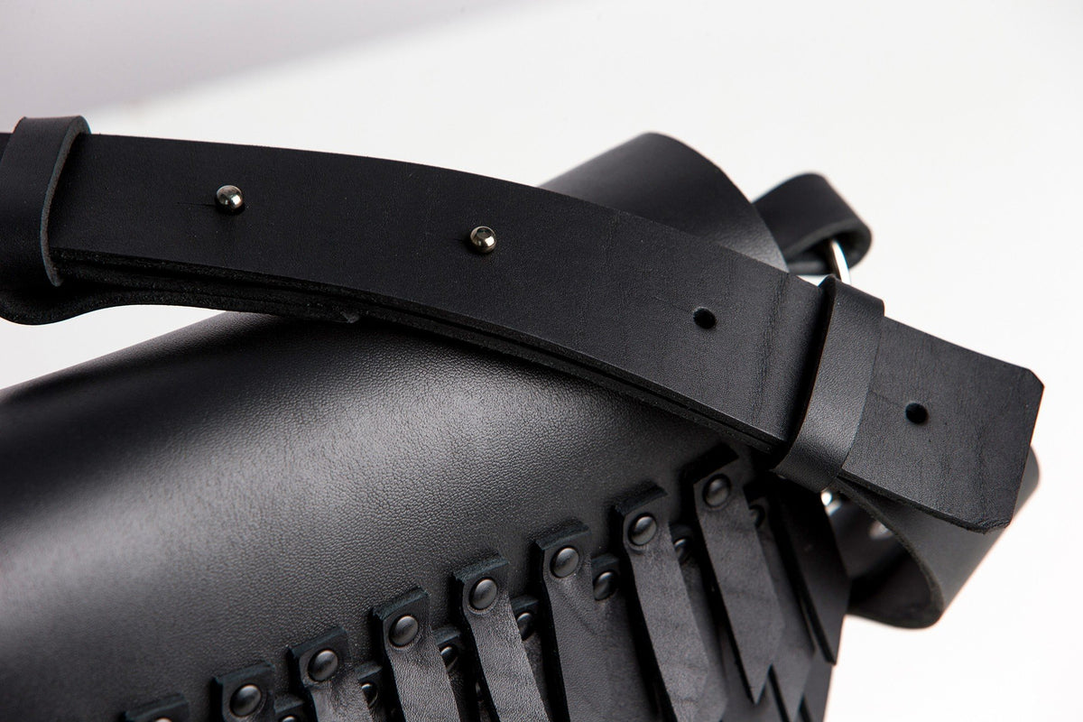 3. Close-up of PYKOK BARBED SISTER handbag showing black leather strap and fringe detail