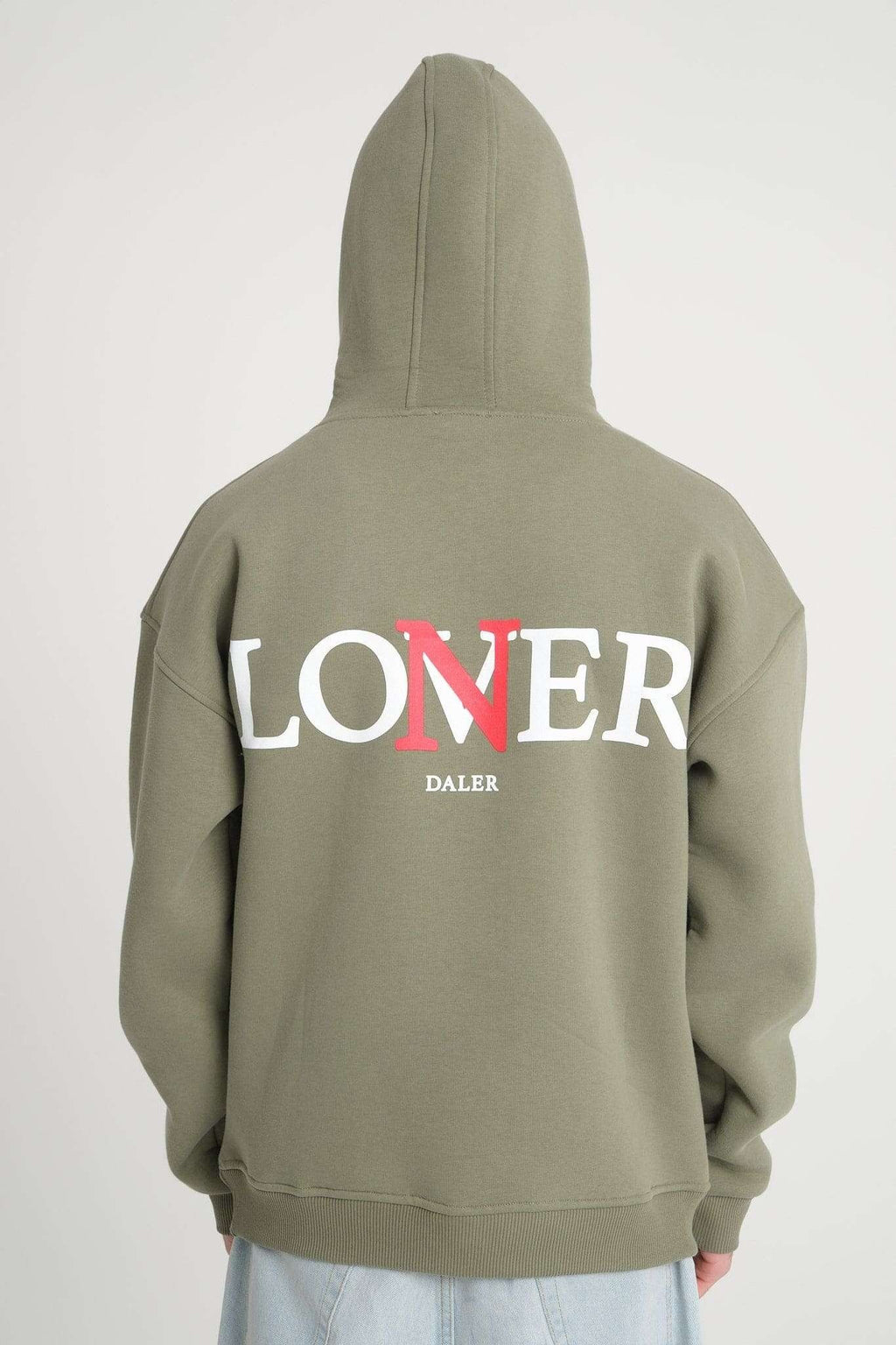 1. Back view of men's olive green hoodie with 'LONER' and 'DALER' print, worn by model in studio setting