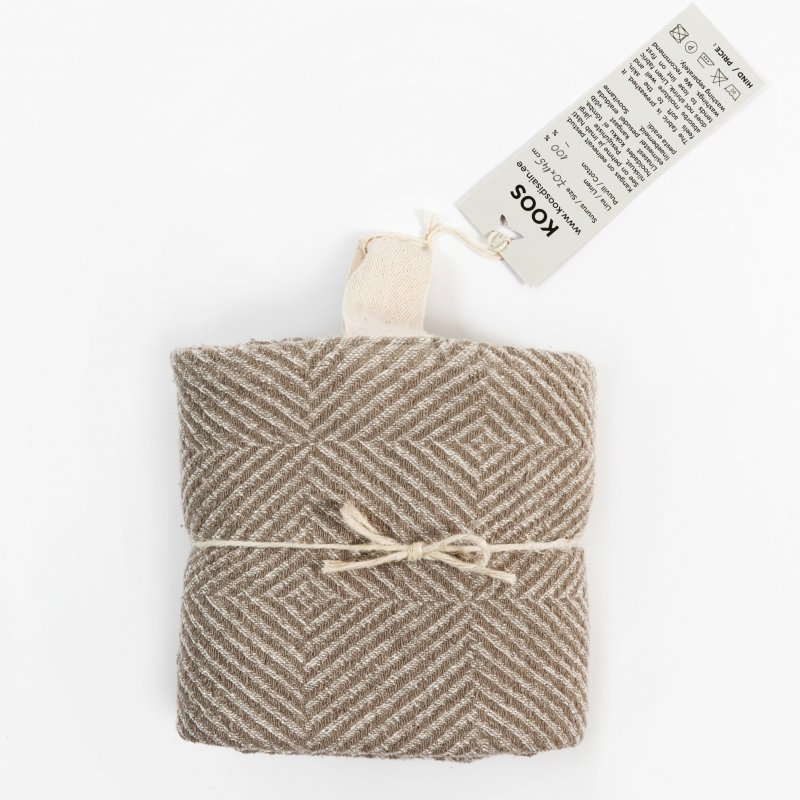 5. Beige linen towel with checkered fishbone pattern, folded and tied with string, featuring KOOSdisain tag