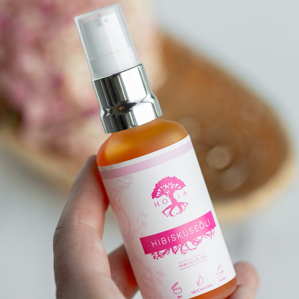 3. Close-up of HOIA homespa Organic Hibiscus Beauty Oil, 50ml, held in hand, showing label details