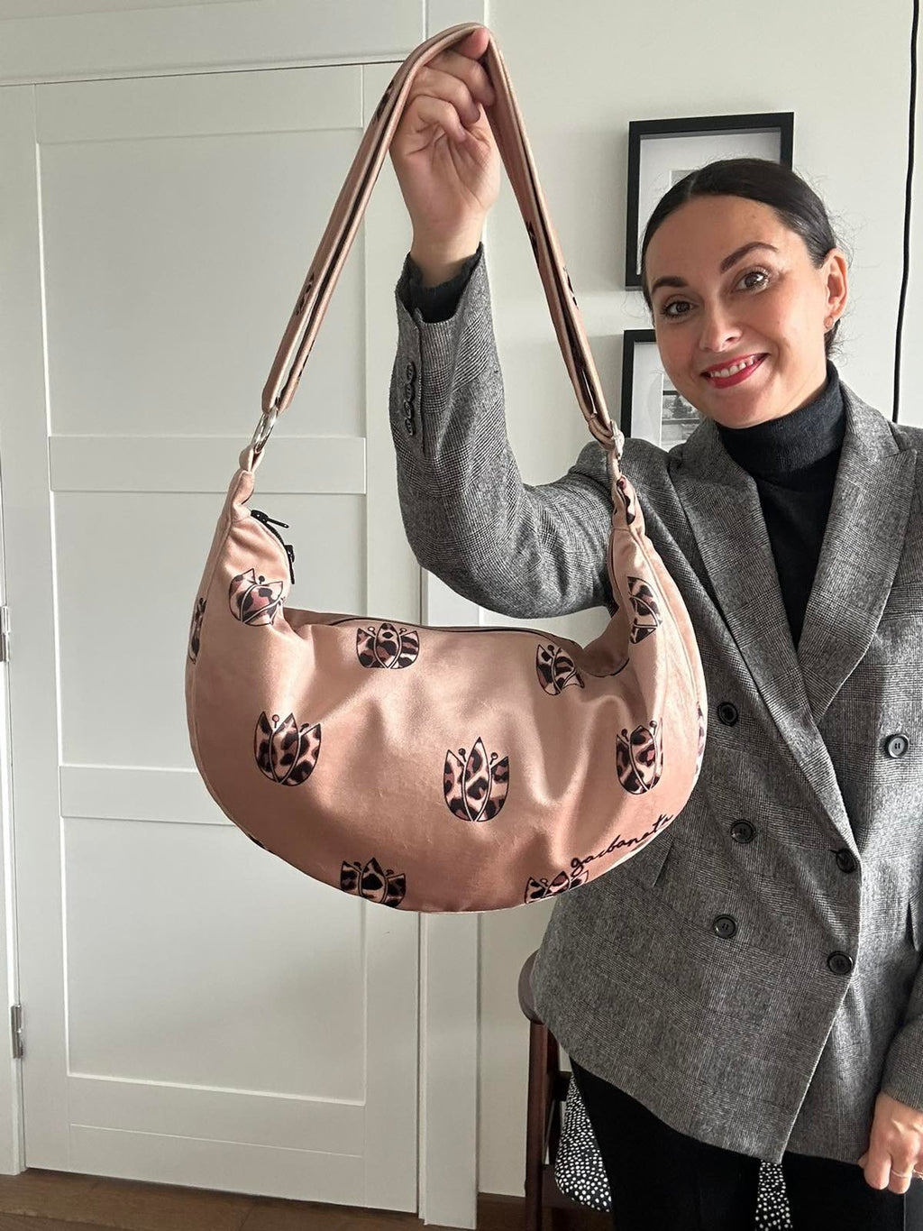 5. Woman holding Garbanota Hobo Bag in Brown Leopard Tulips, shown in indoor setting