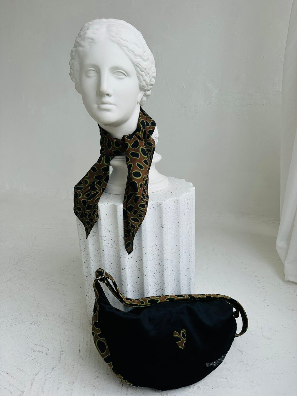 7. Back view of Garbanota Hobo Bag - Leopard Heart with matching scarf on mannequin, highlighting design