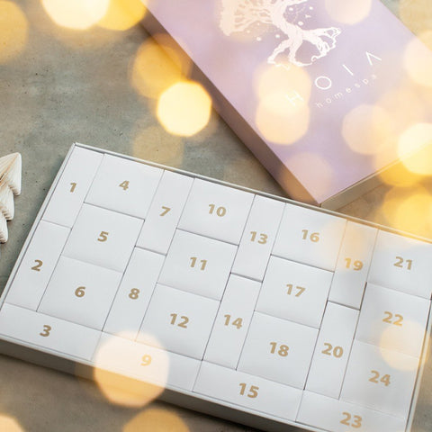 2. Open HOIA Advent Calendar 2025 showing numbered compartments, with pink packaging and festive lights