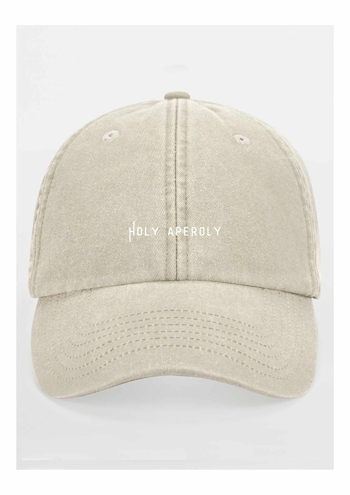 4. Studio shot of pastel beige Holy Aperoly cap by Black Giraffe Brand with white logo on front
