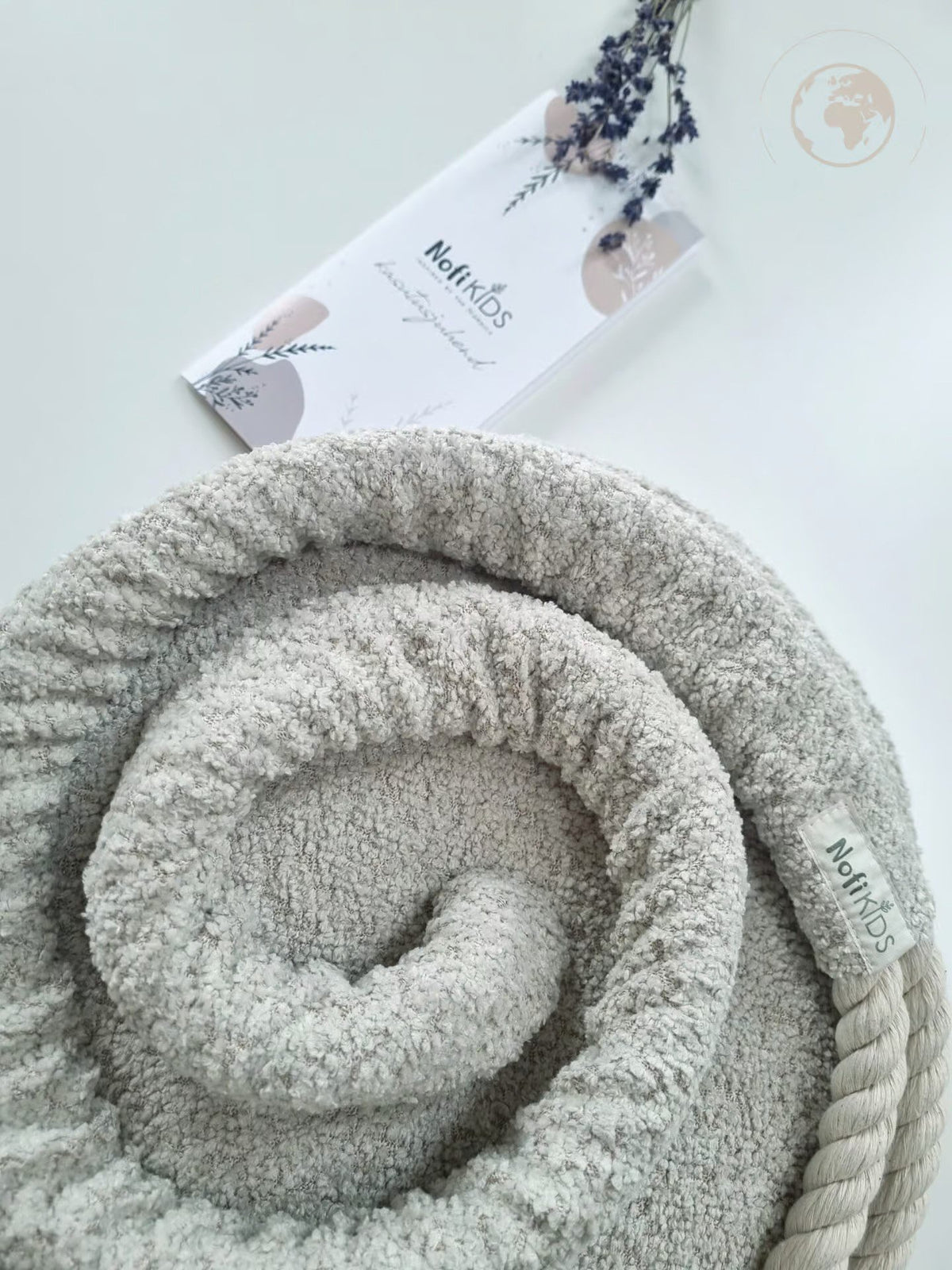 4. Detail of Nofi KIDS bouclé pearl white swing fabric and rope with brand tag