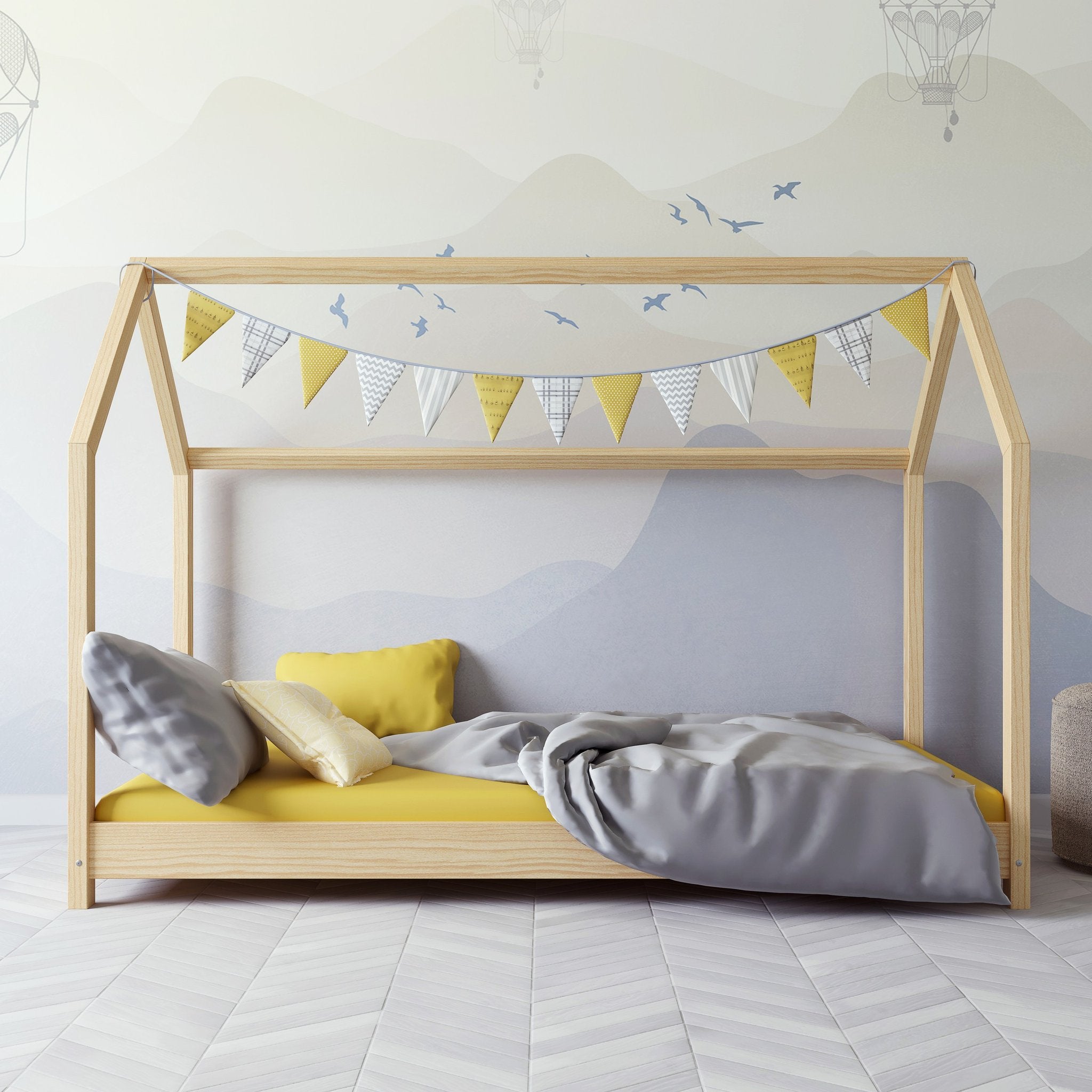 1. Kocot Kids Bella house bed in natural wood with yellow and grey bedding and bunting in a children's room
