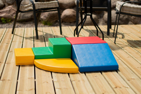 2. Multi-color foam block set arranged on a wooden deck with outdoor furniture in the background