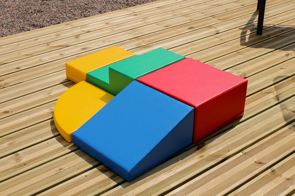 6. Multi-color foam block set arranged on a wooden deck viewed from above