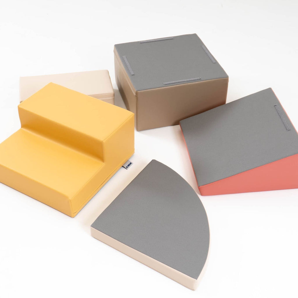 9. Disassembled pastel pink and beige foam blocks showing non-skid bottoms