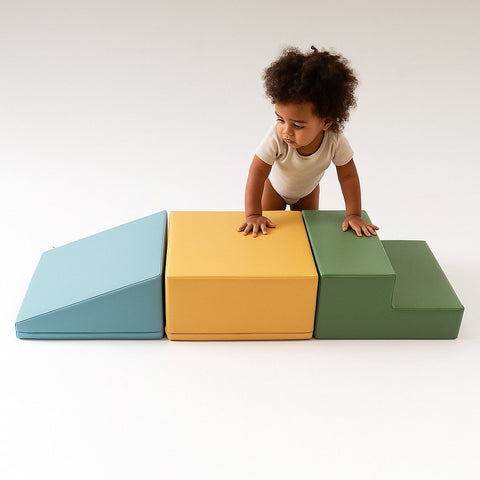 5. Child in white outfit exploring IGLU pastel turquoise, yellow, and green foam blocks in studio setting