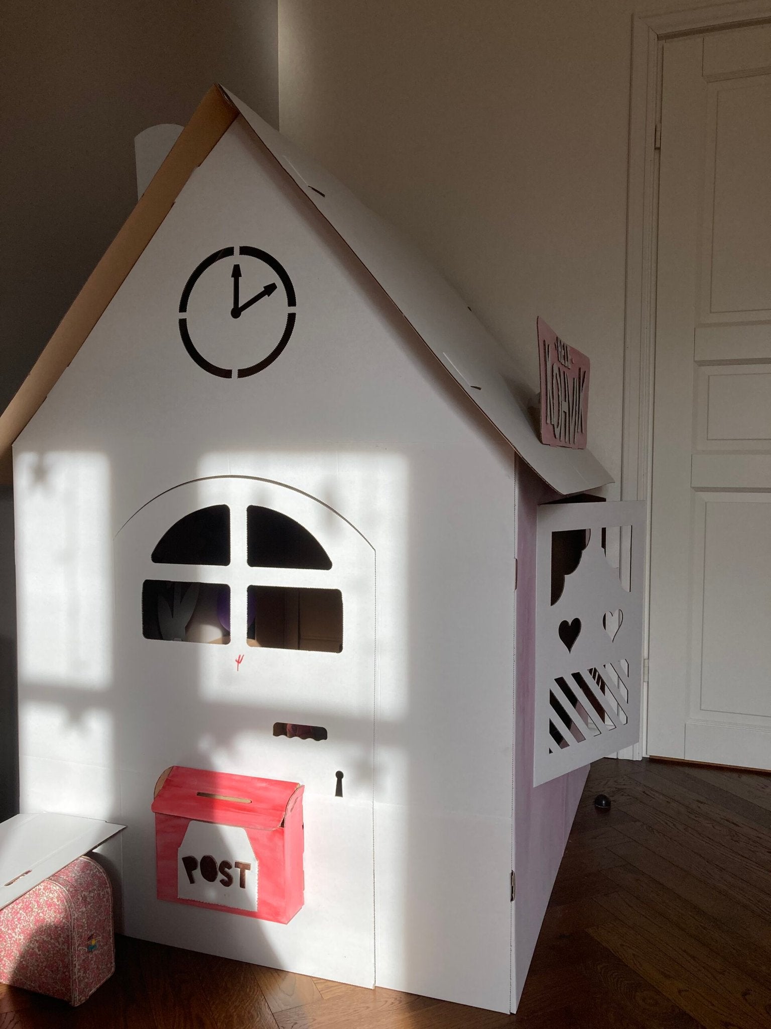 3. SEIK cardboard house for kids styled as a post office with red mailbox, shown indoors
