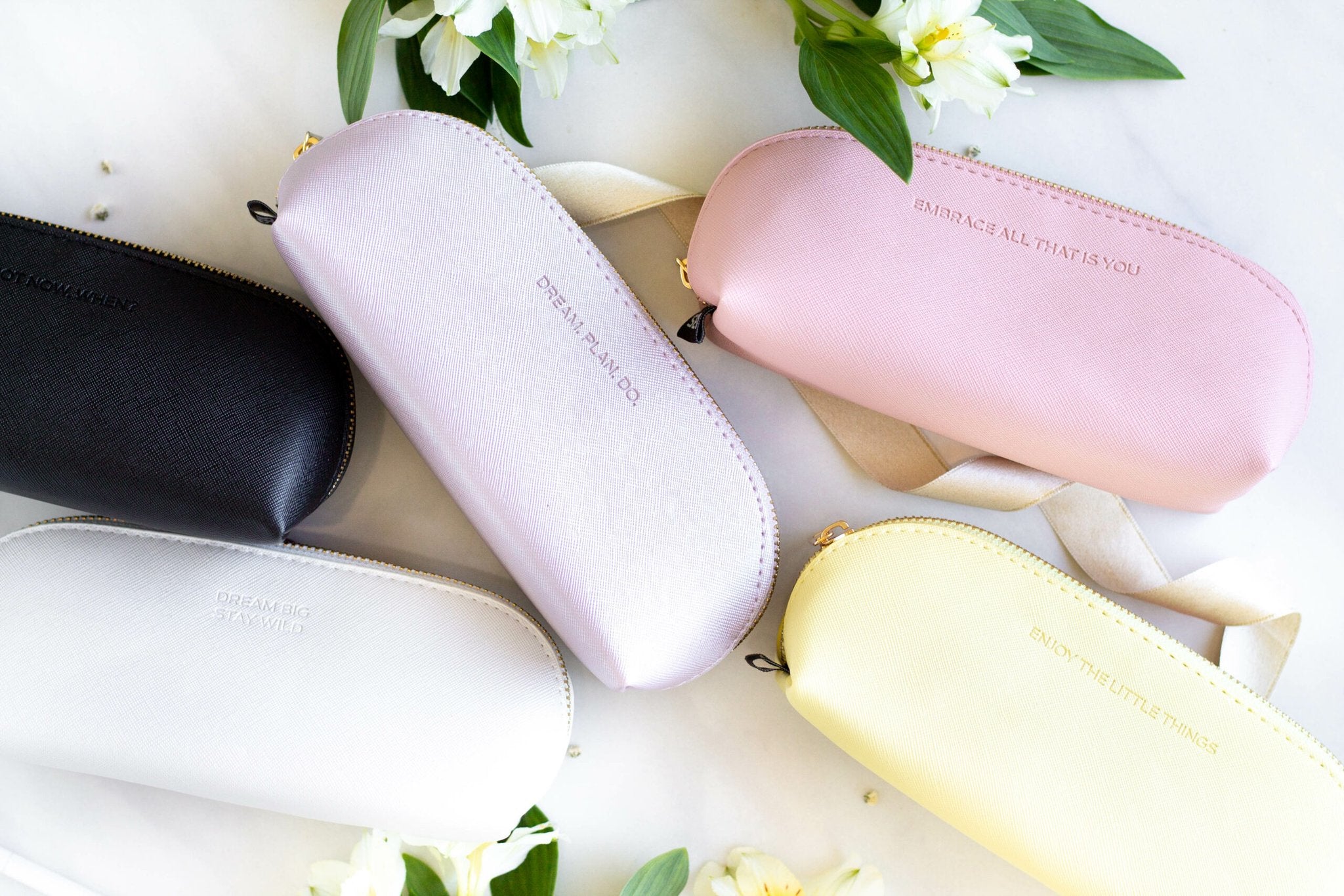 5. Collection of SEIK pencil cases in various colors, including yellow, pink, and black, with motivational texts