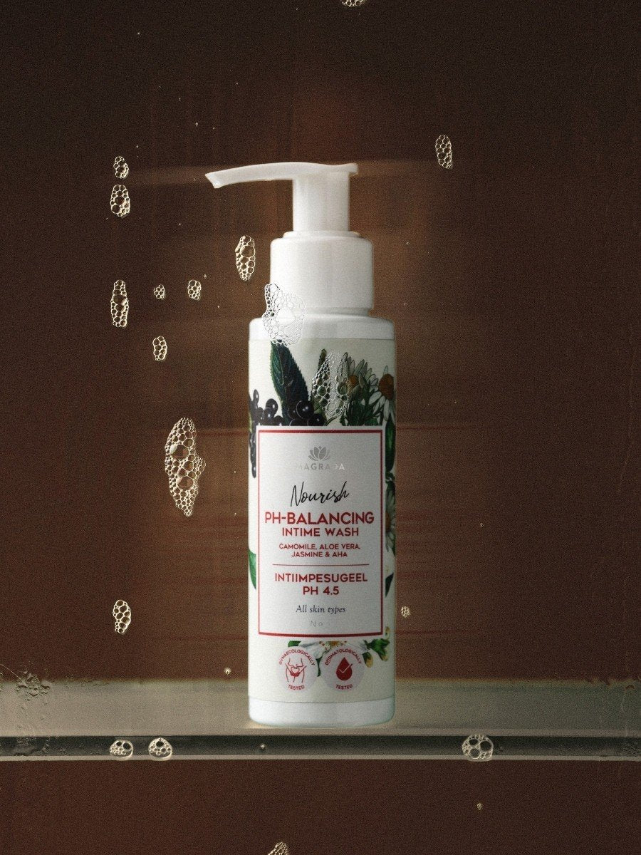 1. Magrada Organic Cosmetics intimate wash gel bottle with chamomile and aloe, pH 4.5, in a shower setting with water droplets