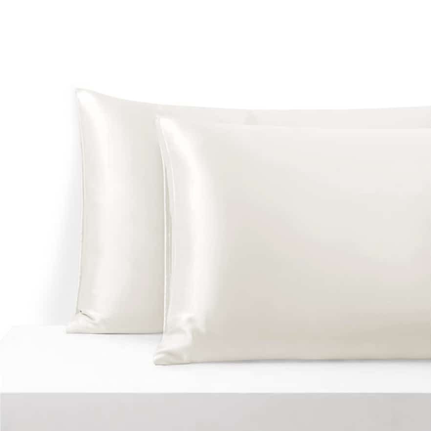 27. Pair of ecru Mulberry silk pillowcases on a white surface, highlighting smooth finish