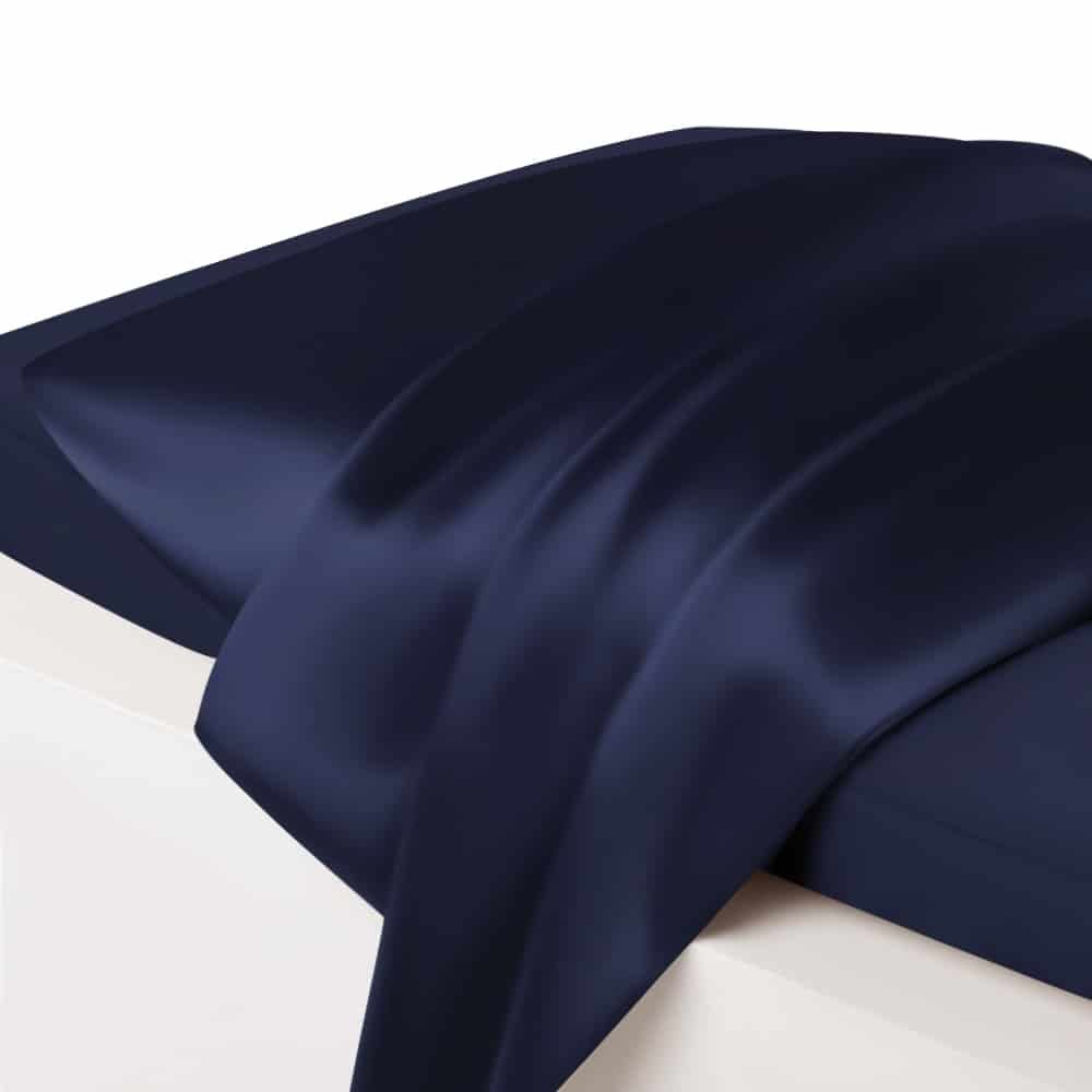 23. Close-up of navy Mulberry silk pillowcase with draped fabric, highlighting sheen