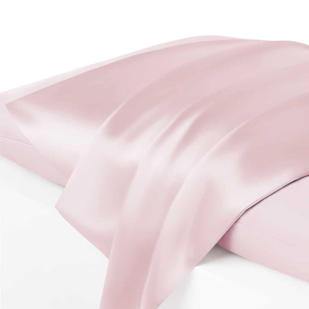 17. Close-up of powder pink Mulberry silk pillowcase with draped fabric, highlighting sheen