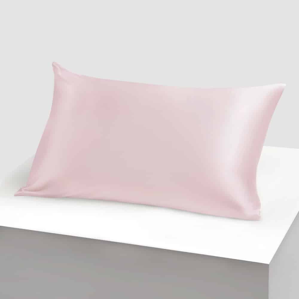 16. Powder pink Mulberry silk pillowcase on a white platform, showcasing smooth finish