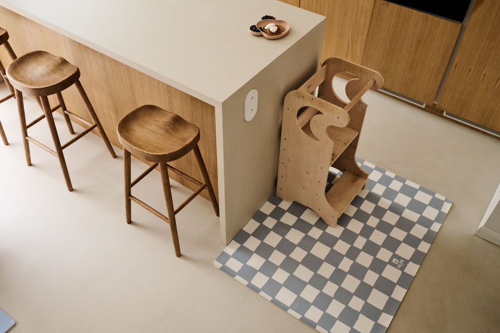 2. Overhead view of kids' blue and white checkered floor mat under wooden high chair in modern kitchen