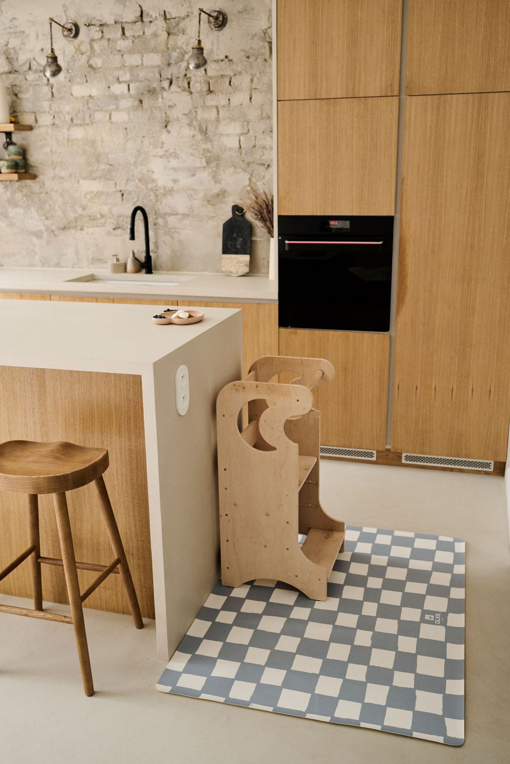 1. Kitchen setting with kids' non-slip waterproof floor mat in blue and white checkered pattern under wooden high chair