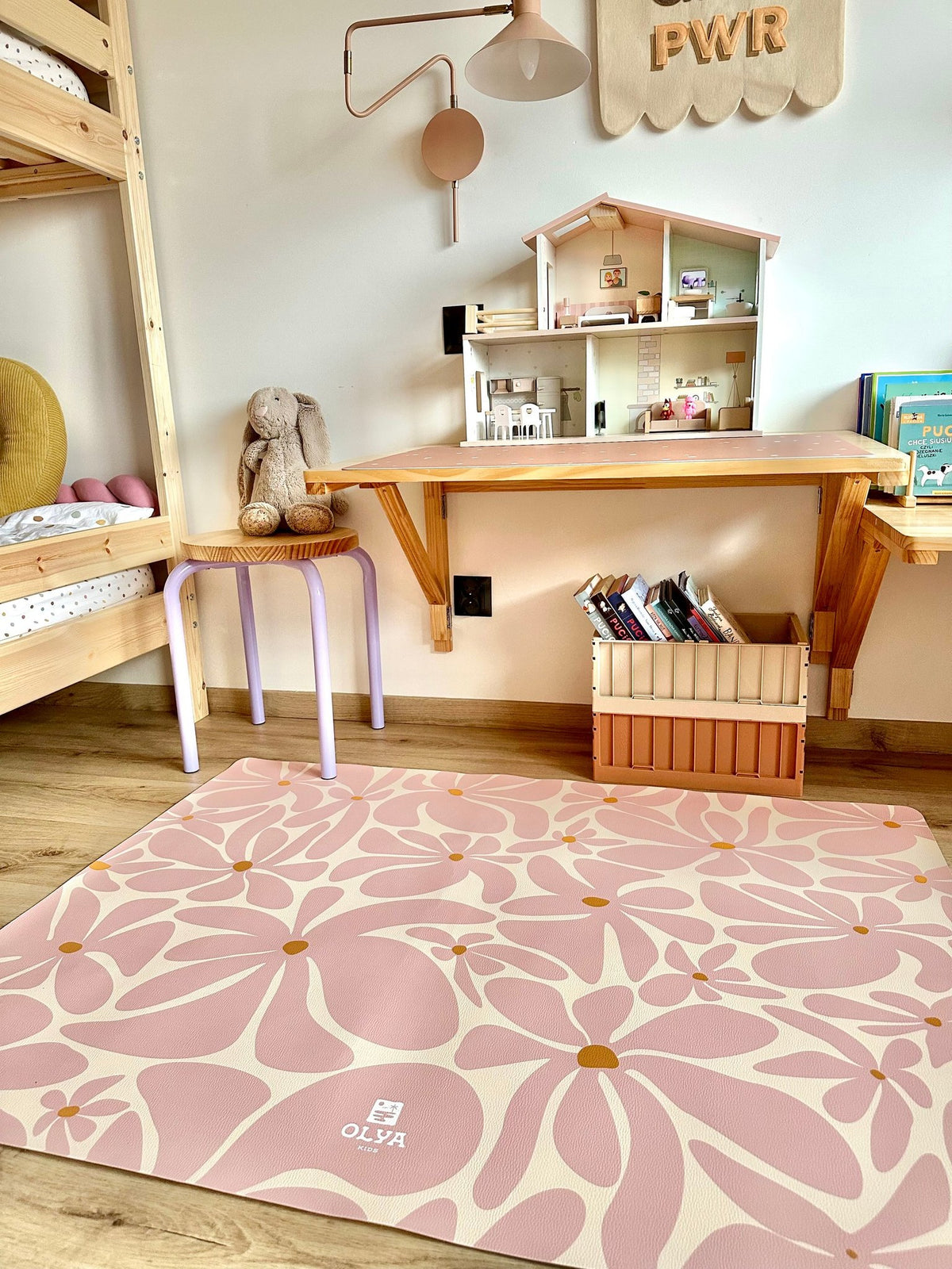 3. Pink daisy-patterned OLYA KIDS floor mat in children's playroom with toys and books
