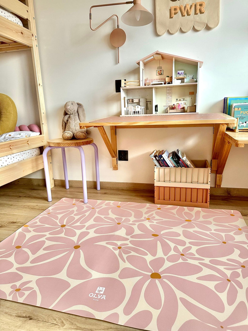 1. Playroom with pink daisy-patterned OLYA KIDS floor mat under play table