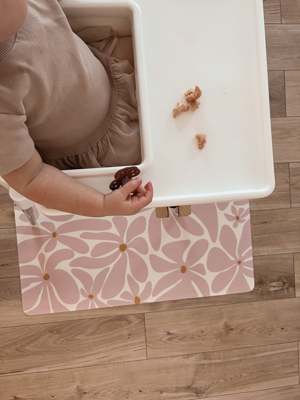 3. Close-up of toddler's hand on pink daisy-patterned OLYA KIDS floor mat