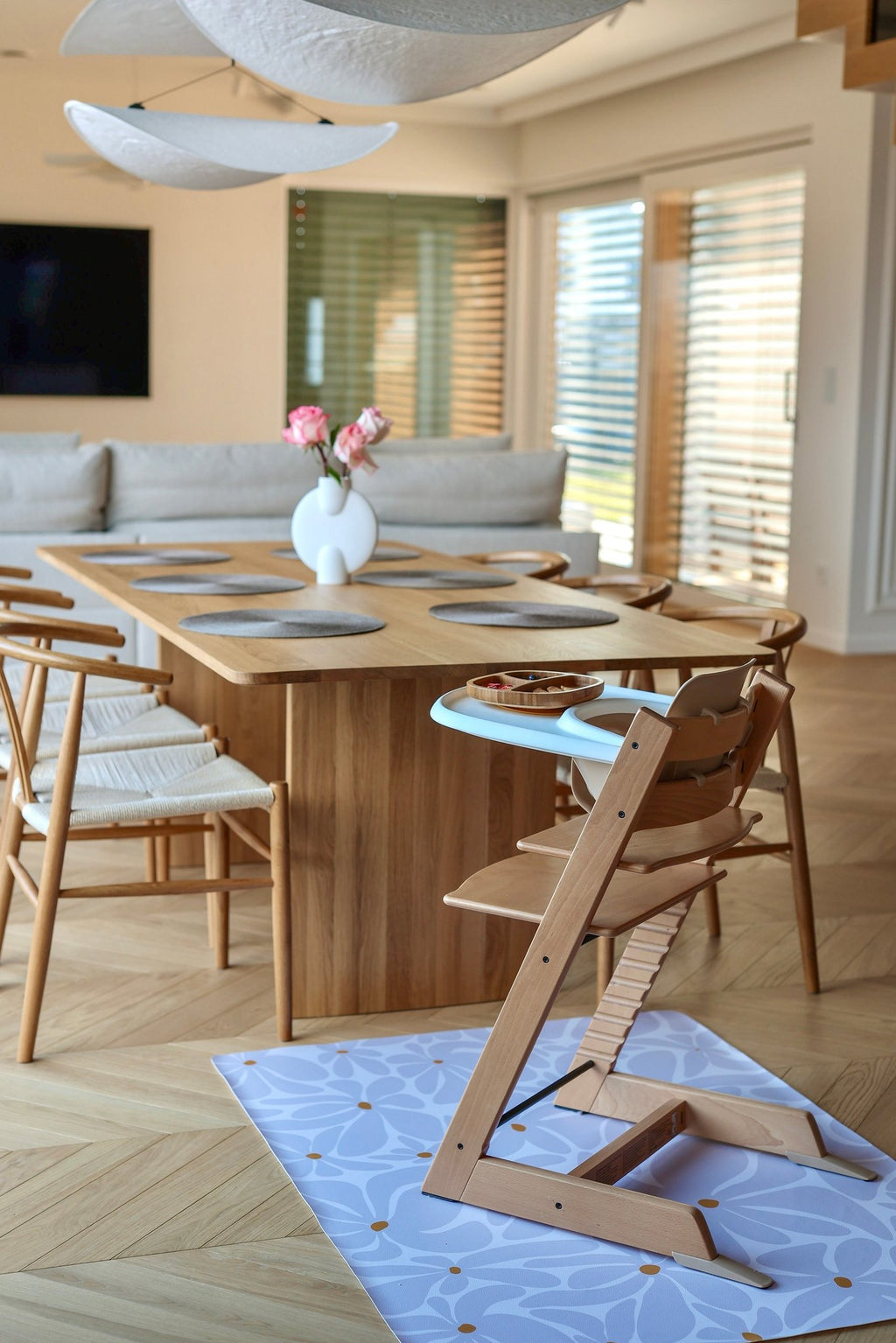 11. Dining room with lavender daisy-patterned floor mat under high chair