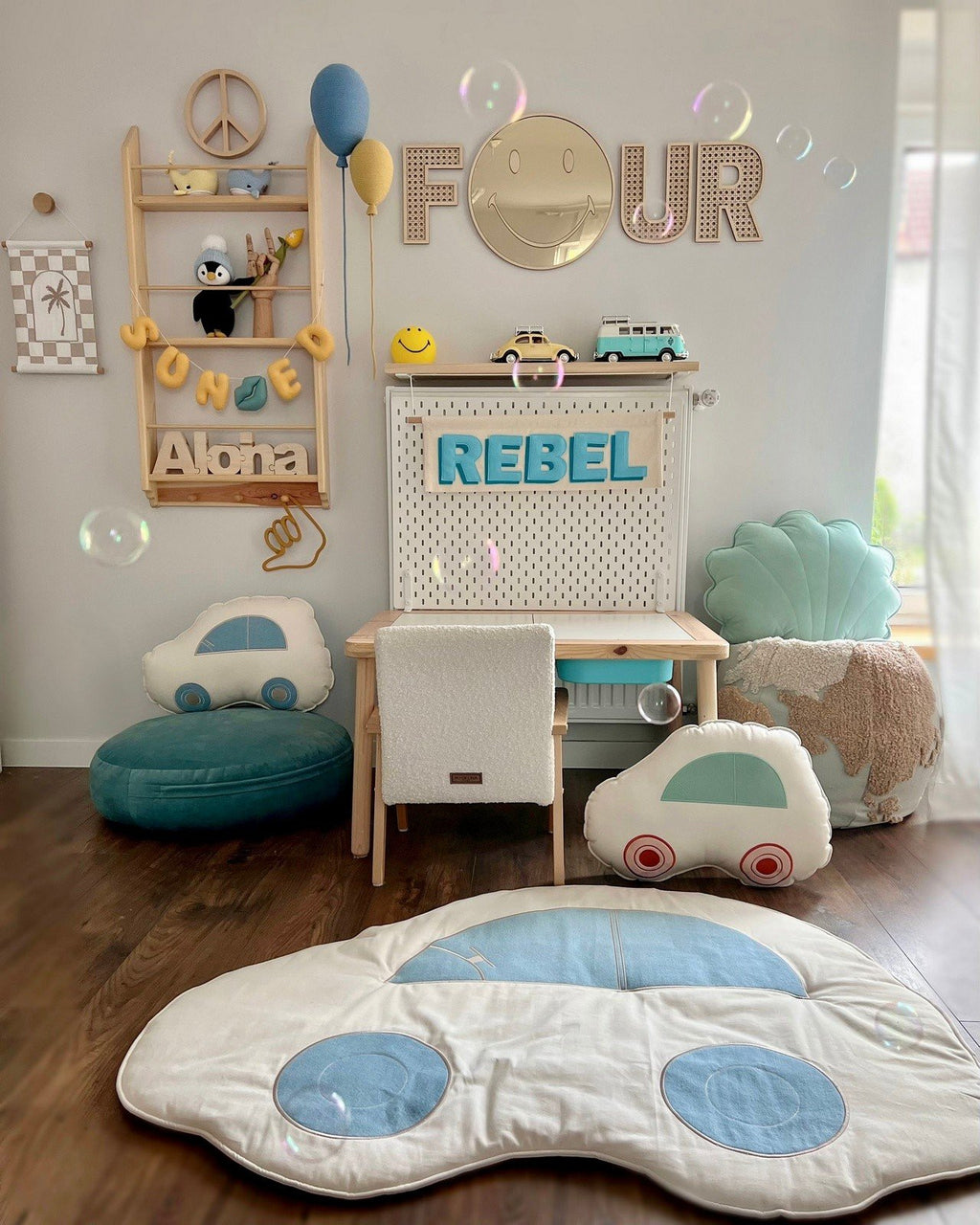 3. Emoji mirror with gold-tinted acrylic in children's room above desk, surrounded by playful decor and cushions