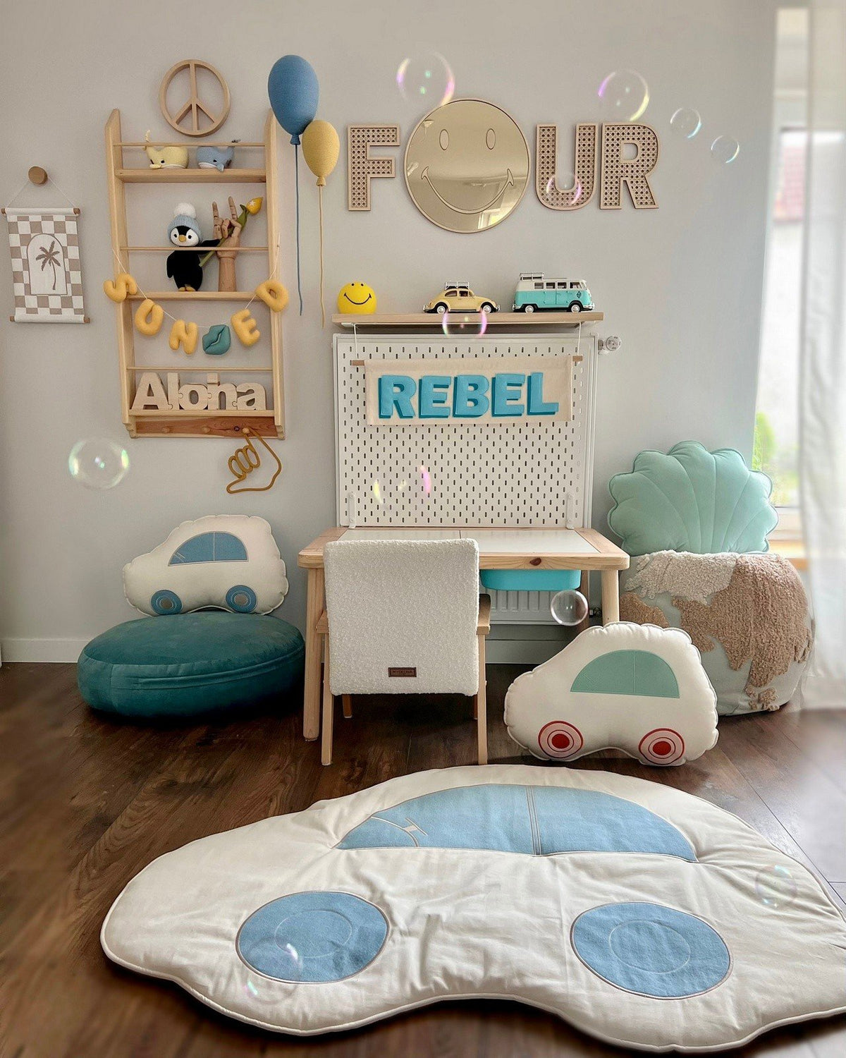 3. Emoji mirror with gold-tinted acrylic in children's room above desk, surrounded by playful decor and cushions