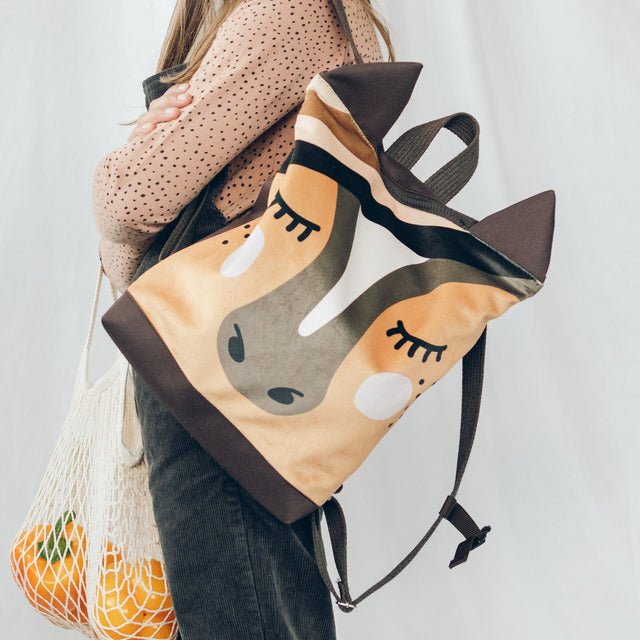 3. Close-up of Muni horse backpack worn by girl, highlighting playful horse design