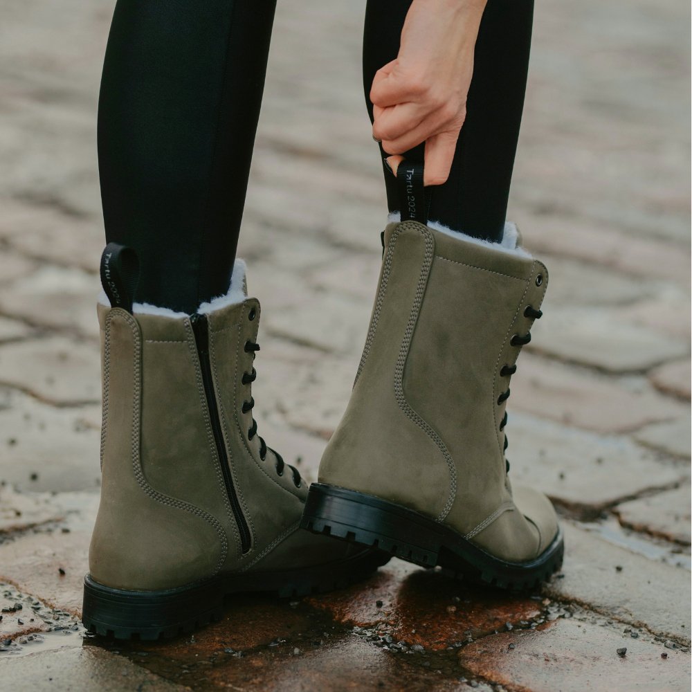 1. Women's KIRA 4.0 olive boots with side zippers and slip-resistant soles, shown outdoors