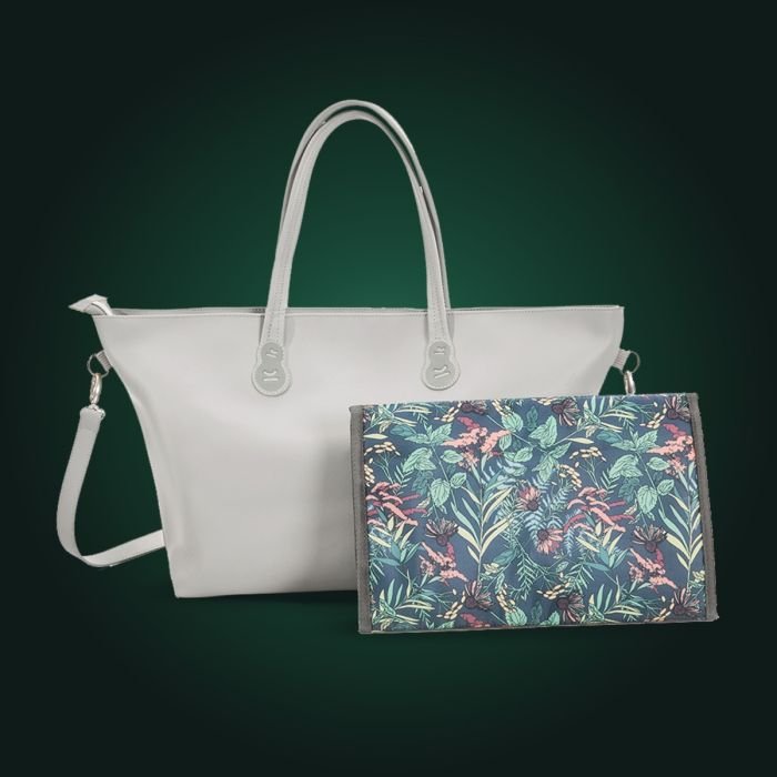 3. Light grey Kinderkraft Treasurebag diaper bag with floral changing pad on dark green background
