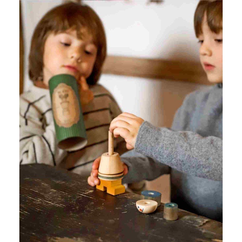 1. Two children playing with wooden stick figure puzzle, one holding a green tube, the other assembling pieces