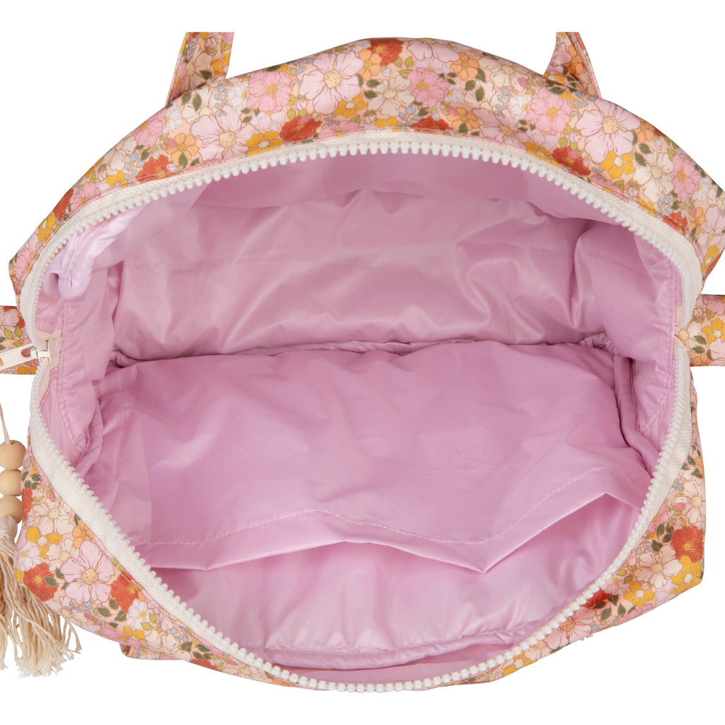 3. Interior view of large floral print makeup bag with pink waterproof lining and pocket