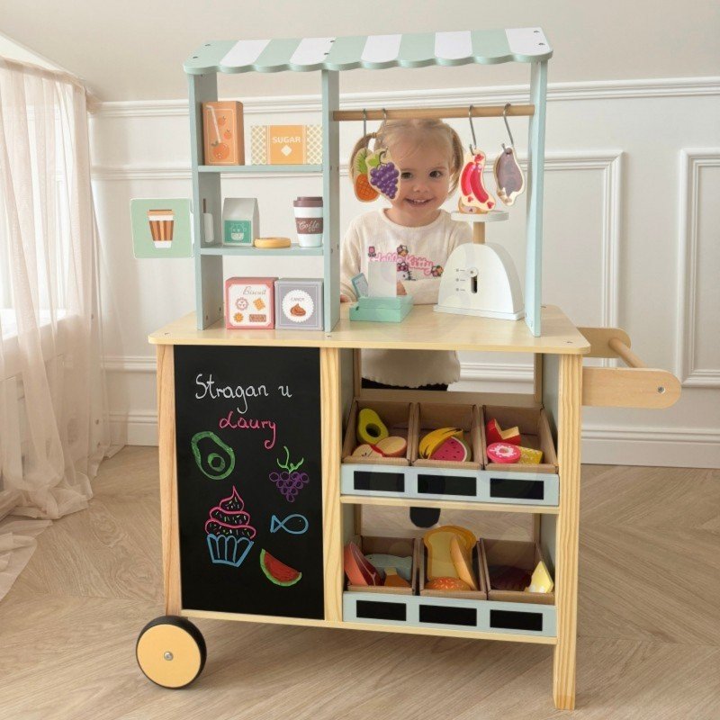 16. Child playing with Woopie Green wooden food truck stand, side view