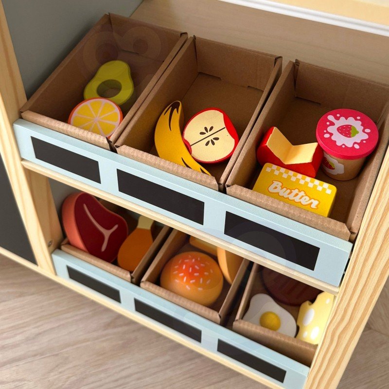 11. Close-up of play food items in storage bins on Woopie Green wooden food truck