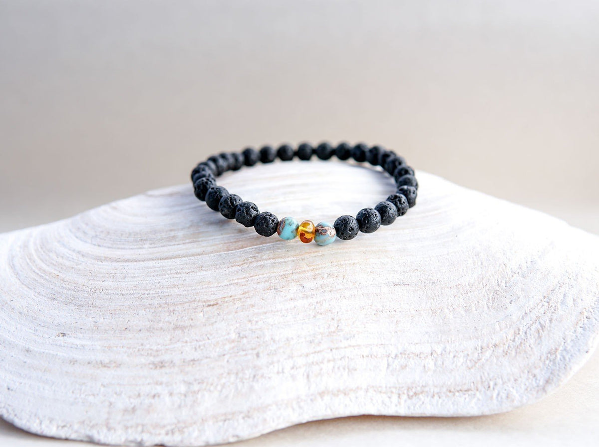 4. Canary Lava stone bracelet with amber and turquoise, showcased on a shell