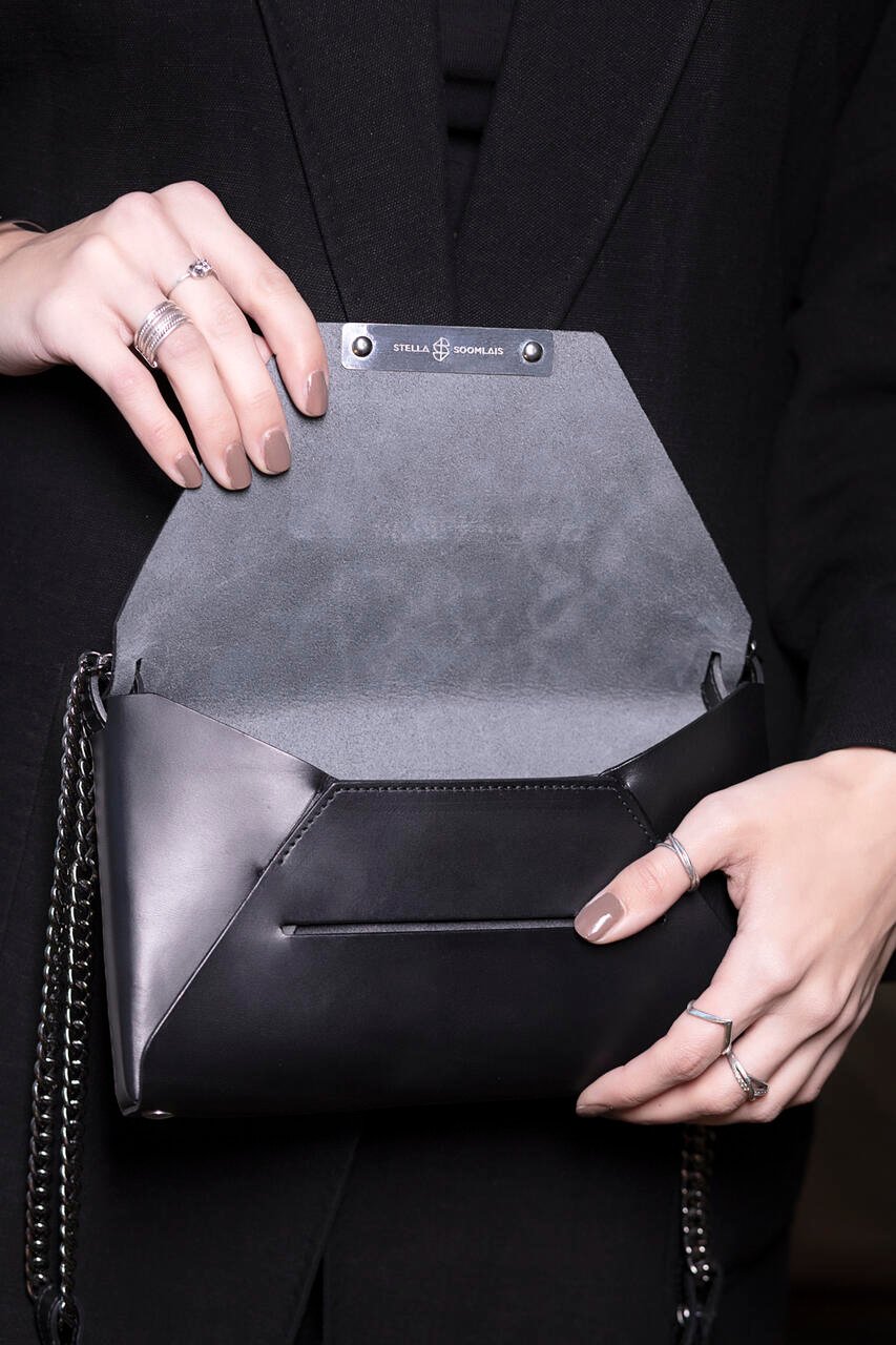4. Open black Stella Soomlais Wine & Dine evening bag showing interior with brand logo and magnetic closure