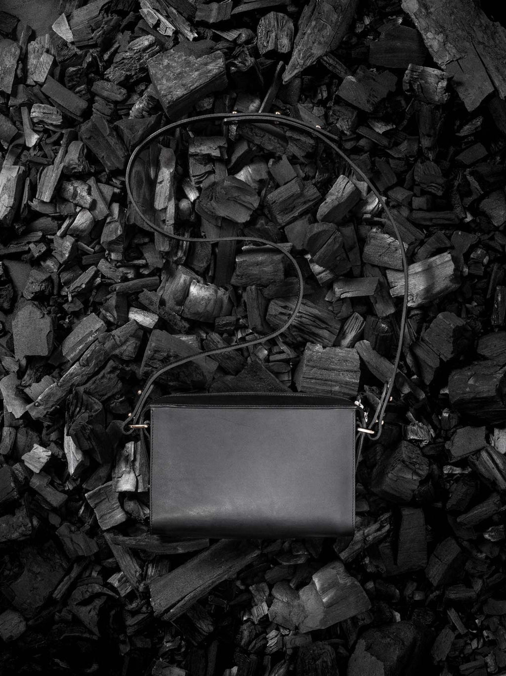 2. Black Stella Soomlais Treasure Box handbag with adjustable strap on dark textured background