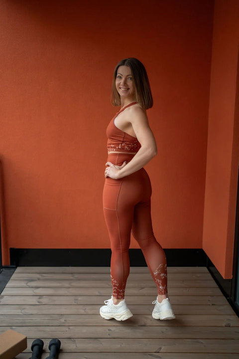 5. Woman in Peachlabel Wildflowers brown sports bra and leggings, styled with white sneakers in lifestyle setting