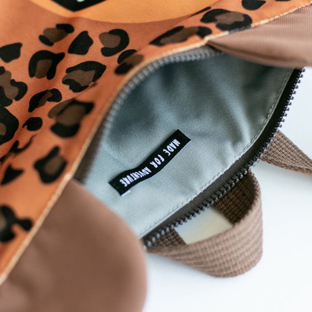9. Close-up of Muni leopard backpack interior, showing zipper and label